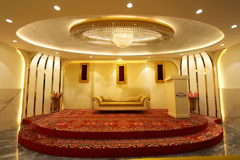 Elegant stage area with sofa and decorative lighting inside the restaurant