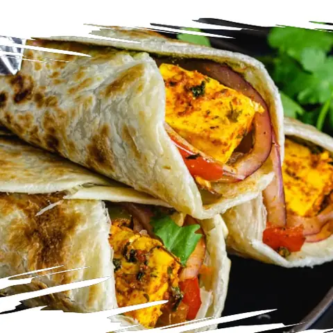 Paneer tikka wrap with onions and tomatoes in flatbread