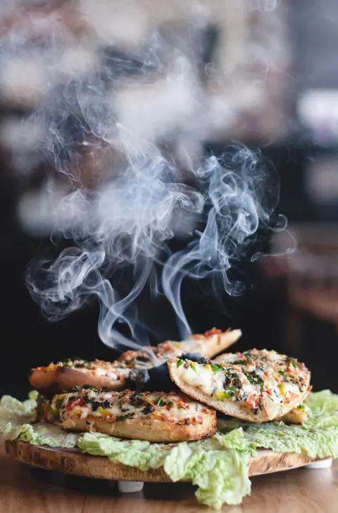 Steaming hot grilled stuffed bread on lettuce leaves