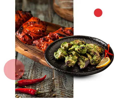 Plate of green grilled chicken and wooden board with red grilled chicken pieces