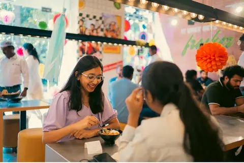 Customers enjoying food inside California Burrito restaurant in Bengaluru