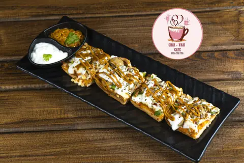 Plate of dahi puri topped with chutneys and sev, served with side dips