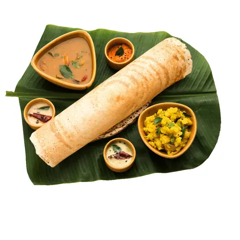 Masala dosa with sambar, chutneys, and potato filling on a banana leaf