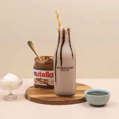Chocolate milkshake in Keventers bottle with Nutella jar and toppings