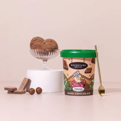 Two scoops of dark chocolate vegan ice cream with chocolate pieces