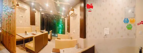 Dining area with tables and chairs inside ShreeRam Hotel