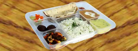 Thali with rice, roti, dal, curry, salad, and dessert