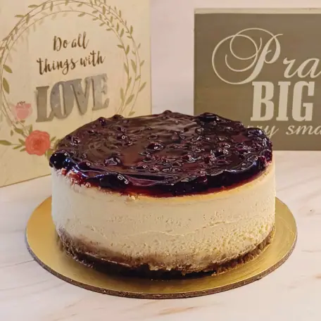 Blueberry cheesecake with a biscuit base on a gold plate