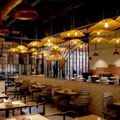 Modern dining area with warm lighting and wooden tables at The Yellow Chilli
