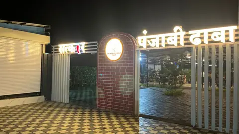 Entrance gate of Satkar Pure Veg Punjabi Dhaba at night