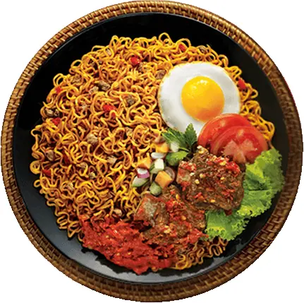 Plate of fried noodles with fried egg, tomato, lettuce, and spicy chutney