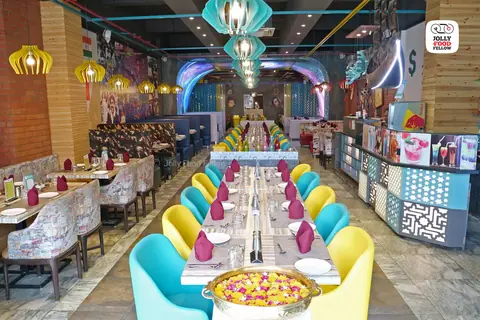 Colorful dining area with long tables and decorative lighting
