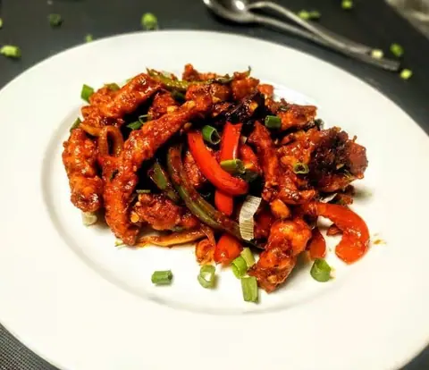 Spicy Chinese-style chicken feet with bell peppers and spring onions
