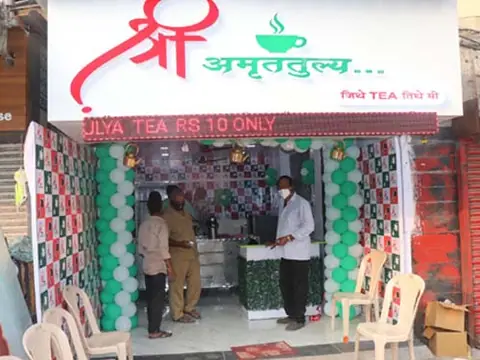 Front view of Shree Amruttulya cafe decorated with green and white balloons