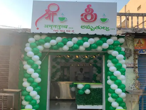 Exterior of Shree Amruttulya cafe decorated with green and white balloons