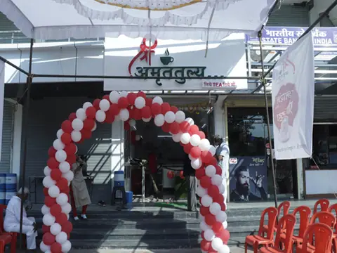 Entrance of Shree Amruttulya cafe decorated with red and white balloons