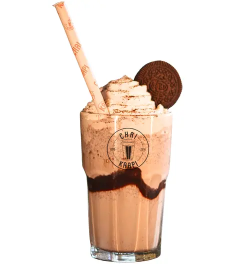 Chocolate milkshake with whipped cream and Oreo cookie in a glass