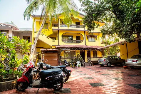 Yellow building exterior of Sea View Restaurant with parked vehicles
