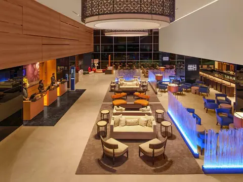 Spacious modern restaurant interior with seating and ambient lighting