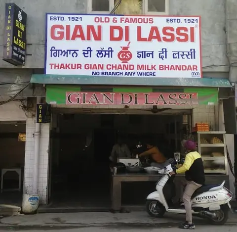 Front view of Gian Di Lassi shop in Amritsar with signboard and scooter