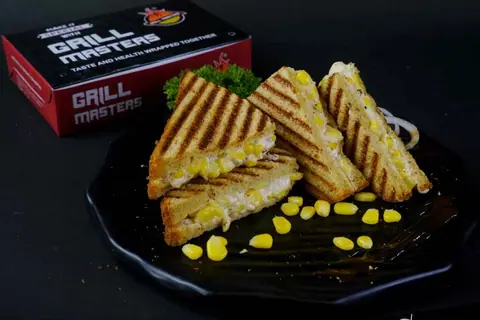 Grilled sandwich with corn and filling on a black plate